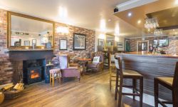 lamlash bay hotel bar with logs burning in burner